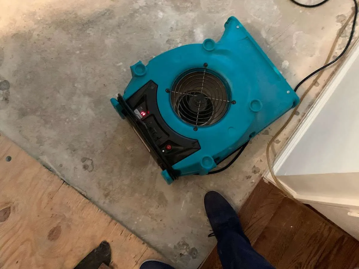Air mover drying subfloor during Commercial Water Damage Restoration in Redwood City